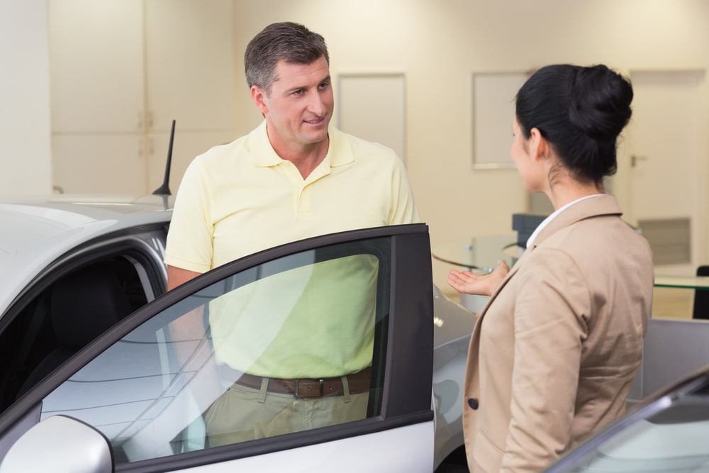Salesperson,Talking,With,Her,Customer,At,New,Car,Showroom qualities of a car salesperson