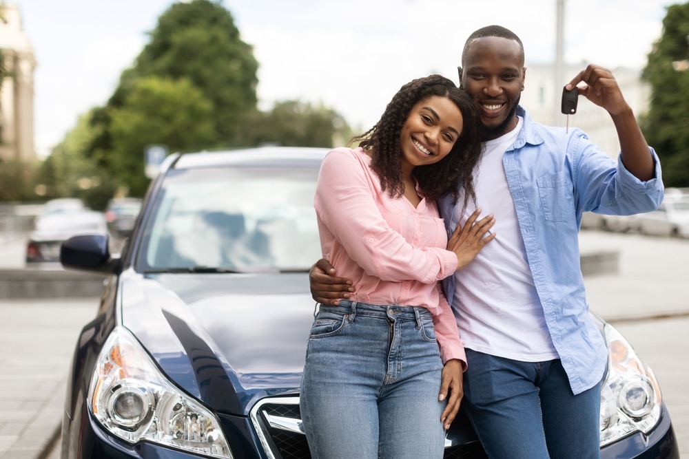 Happy,Black,Man,Showing,Keys,Of,Luxuy,Automobile,,Wife,Embracing
